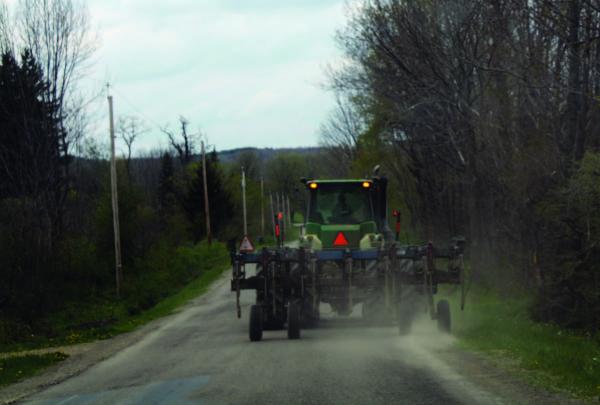 Tractor with slow moving sign on road